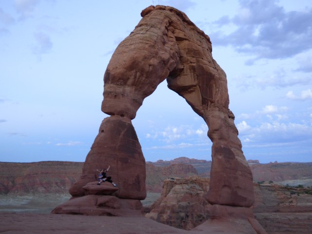 Maddy and Susie at Delicate Arch at sunrise in Arches National Park.